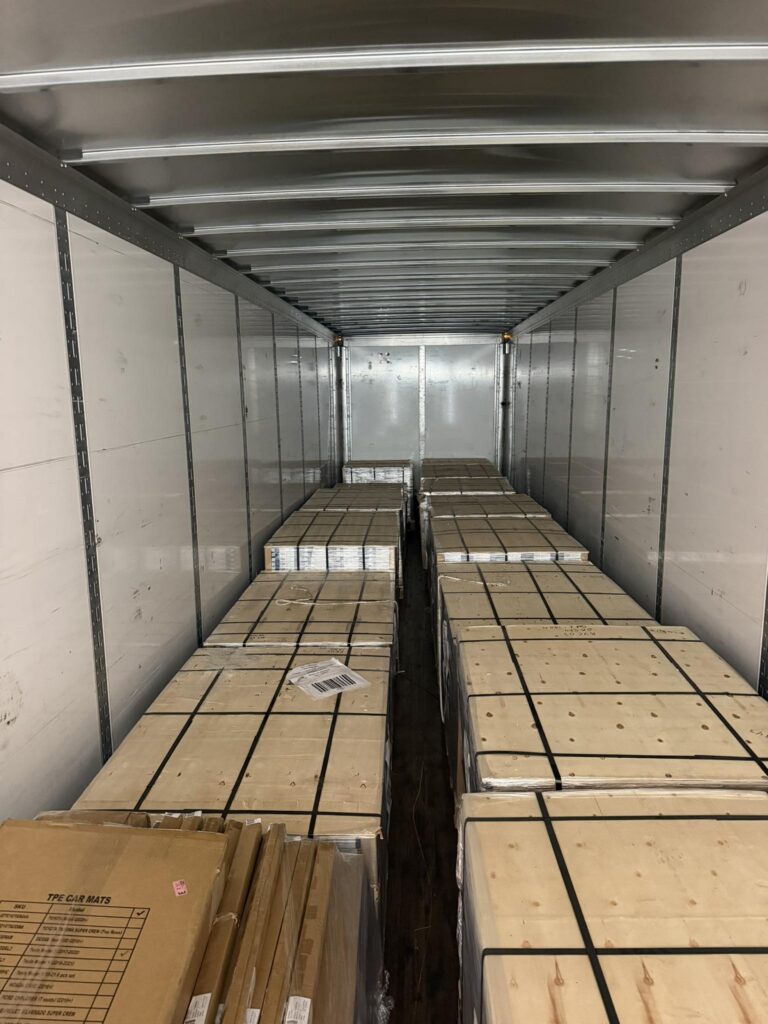 Delivery truck packed floor-to-ceiling with wrapped pallets of 1800LVP flooring